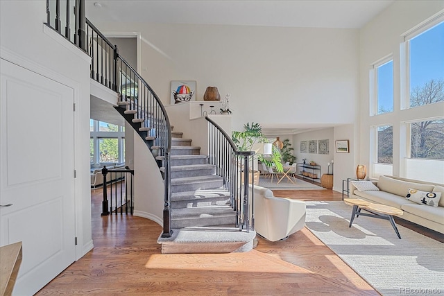 10127 W 100th Ct, Westminster, CO 80021 - stairs featuring a towering ceiling, wood finished floors, and baseboards