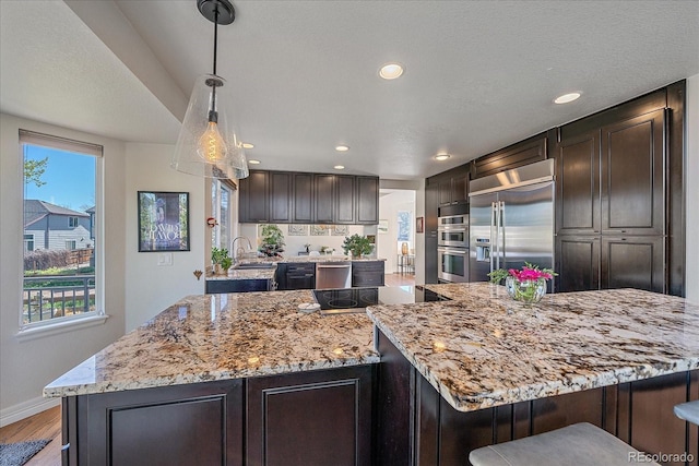 10127 W 100th Ct, Westminster, CO 80021 - kitchen featuring a sink, stainless steel appliances, recessed lighting, light wood-style floors, and baseboards