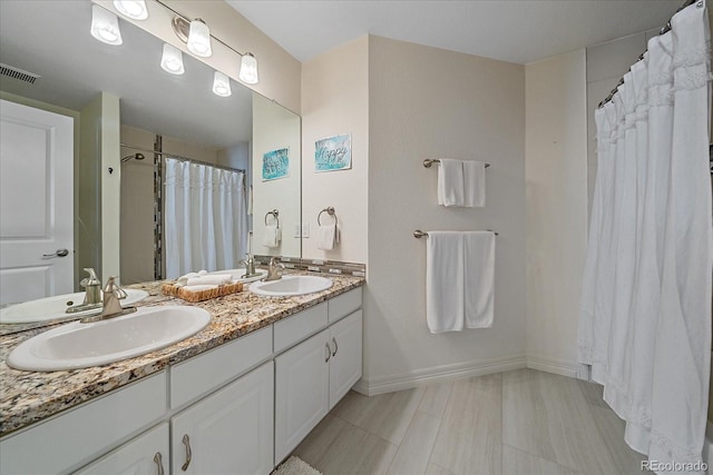10127 W 100th Ct, Westminster, CO 80021 - bathroom with double vanity, baseboards, and a shower with shower curtain