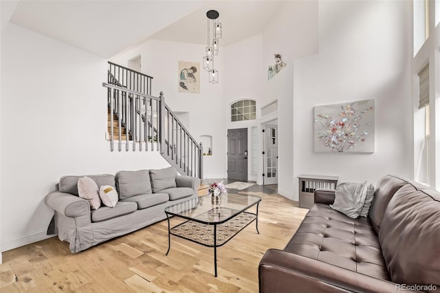1588 W 111th Ave, Northglenn, CO 80234 - living room featuring stairs, wood finished floors, and a towering ceiling