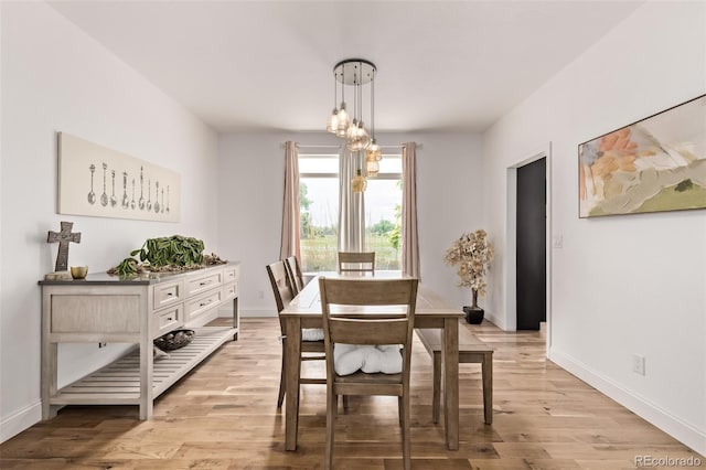 1588 W 111th Ave, Northglenn, CO 80234 - dining area with light wood-style flooring and a chandelier