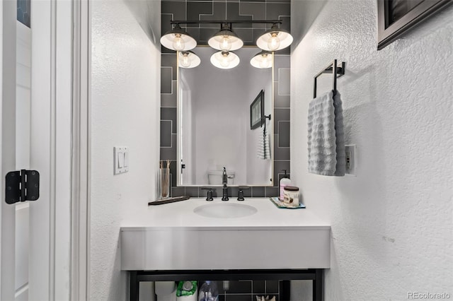 1588 W 111th Ave, Northglenn, CO 80234 - bathroom featuring a textured wall and vanity