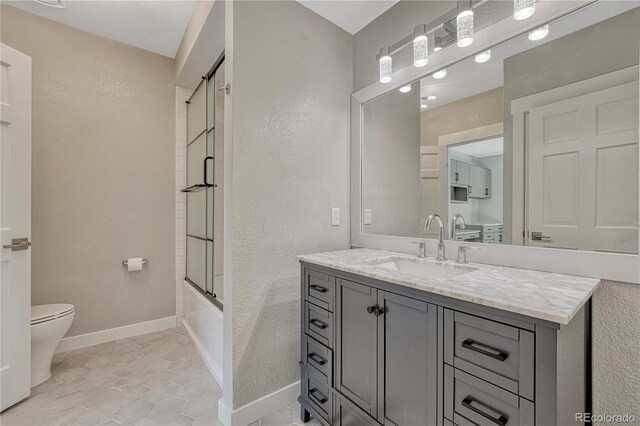1915 Hunters Point Ln, Colorado Springs, CO 80919 - full bath with vanity, a textured wall, enclosed tub / shower combo, and tile patterned floors