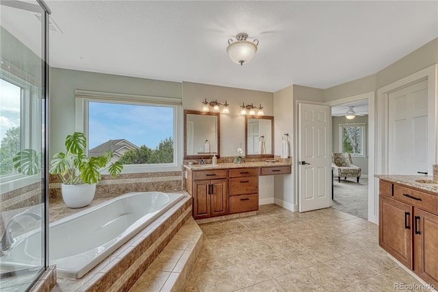 1915 Hunters Point Ln, Colorado Springs, CO 80919 - full bath featuring vanity, a garden tub, and plenty of natural light