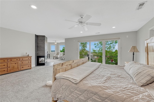 1915 Hunters Point Ln, Colorado Springs, CO 80919 - bedroom with access to exterior, carpet floors, recessed lighting, a multi sided fireplace, and ceiling fan