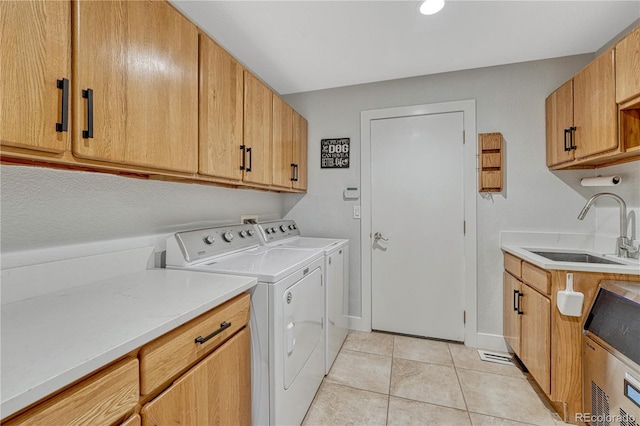 1915 Hunters Point Ln, Colorado Springs, CO 80919 - washroom with separate washer and dryer, cabinet space, and light tile patterned flooring