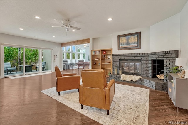 1915 Hunters Point Ln, Colorado Springs, CO 80919 - living area with a fireplace, a ceiling fan, wood finished floors, and recessed lighting