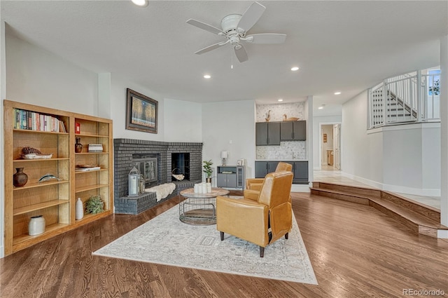 1915 Hunters Point Ln, Colorado Springs, CO 80919 - living area featuring a fireplace, ceiling fan, dark wood finished floors, and recessed lighting