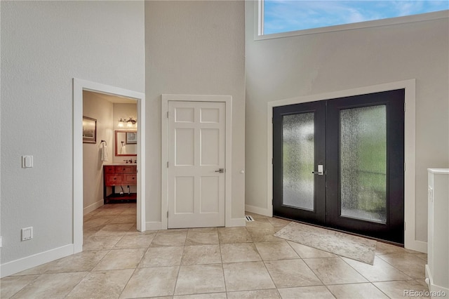 1915 Hunters Point Ln, Colorado Springs, CO 80919 - foyer entrance featuring french doors, a towering ceiling, and tile patterned floors