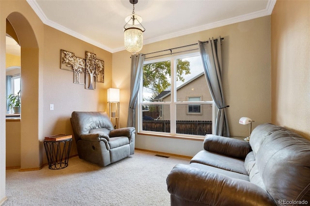 sitting room featuring light colored carpet, an inviting chandelier, and crown molding