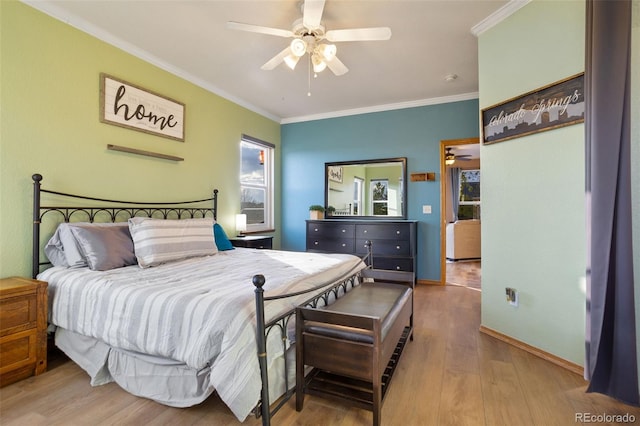 bedroom featuring crown molding, hardwood / wood-style flooring, and ceiling fan