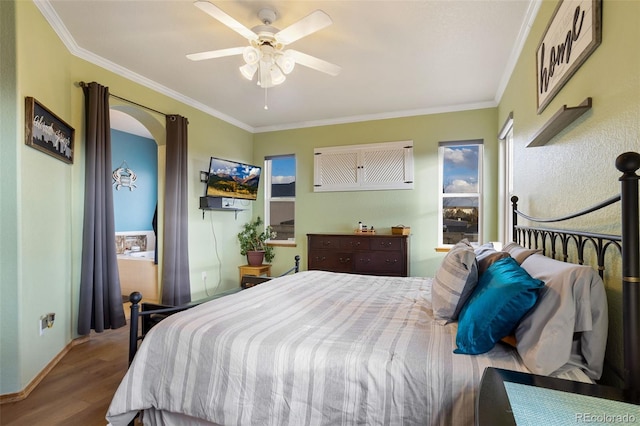 bedroom with ornamental molding, wood-type flooring, and ceiling fan