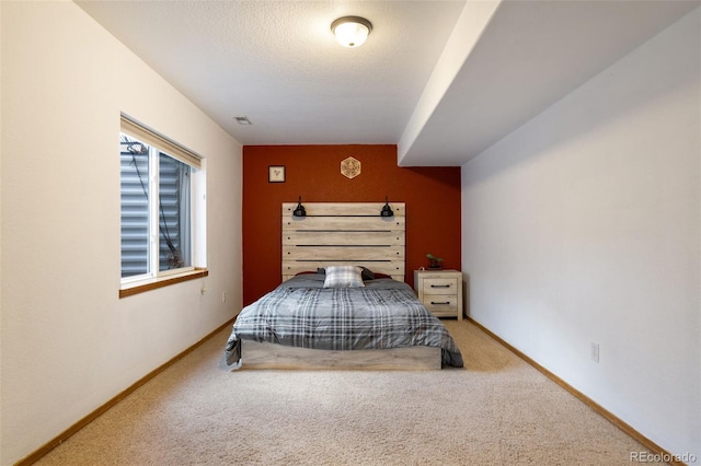 carpeted bedroom featuring a textured ceiling