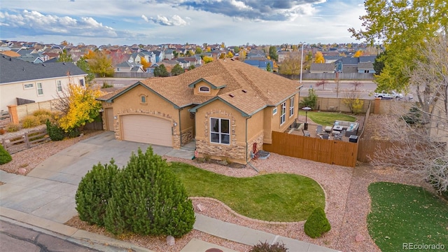 view of front of property featuring a garage and a front lawn