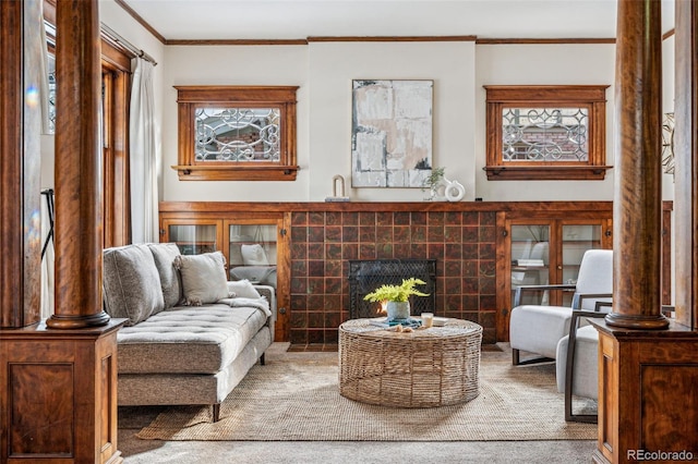 living area with crown molding and a fireplace