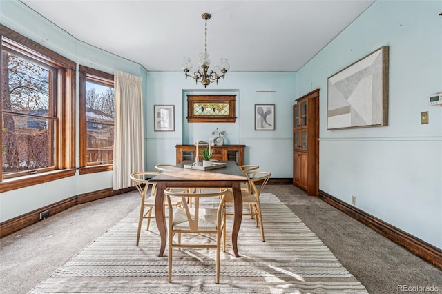 carpeted dining area with a notable chandelier