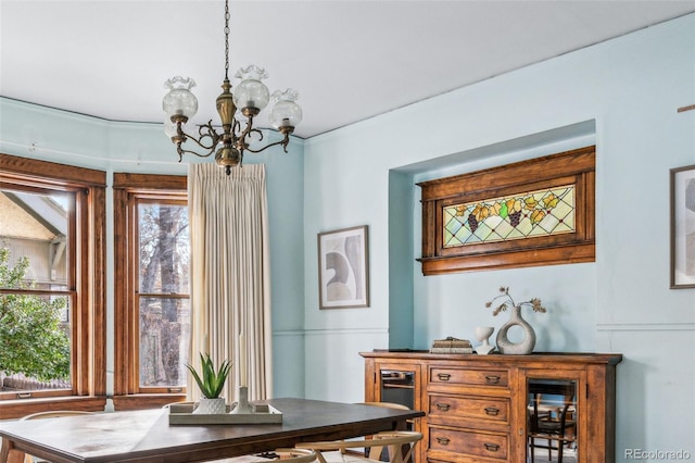 dining space featuring an inviting chandelier and a healthy amount of sunlight