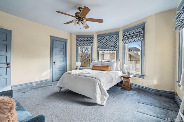 bedroom with multiple windows, carpet floors, and ceiling fan