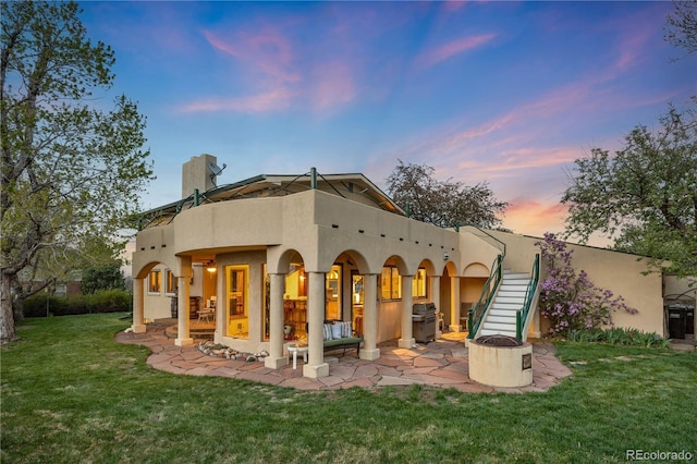 1069 Crestmoor Dr, Boulder, CO 80303 - back of property featuring a patio area, a chimney, stucco siding, and a yard