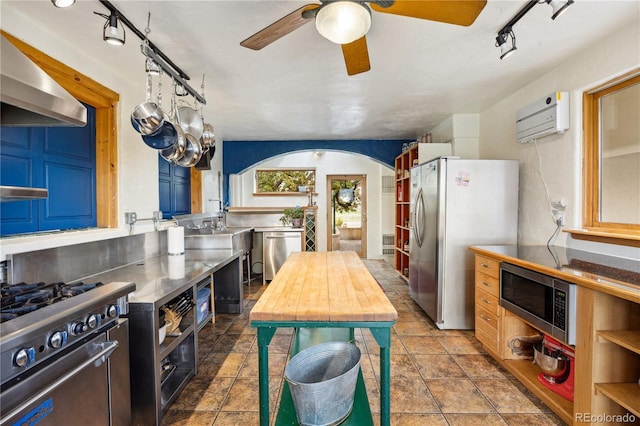 1069 Crestmoor Dr, Boulder, CO 80303 - kitchen with stainless steel countertops, stainless steel appliances, rail lighting, a ceiling fan, and a wall unit AC