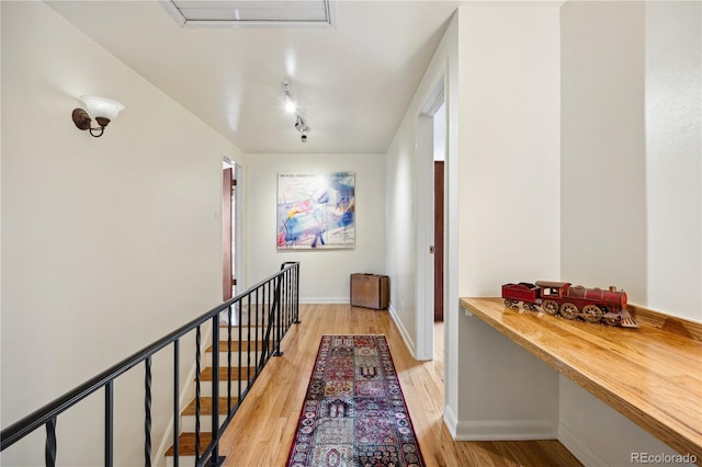1069 Crestmoor Dr, Boulder, CO 80303 - hall featuring light wood-type flooring, baseboards, and an upstairs landing