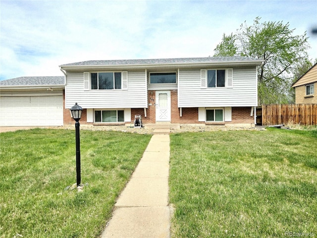 465 Salem St, Aurora, CO 80011 - bi-level home featuring a garage, brick siding, and driveway