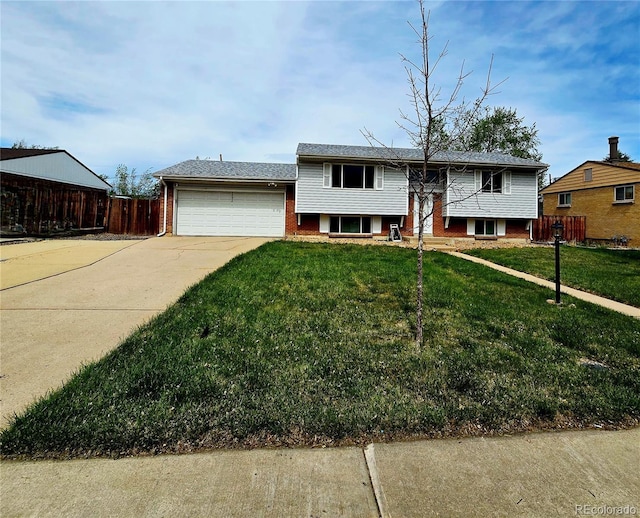 465 Salem St, Aurora, CO 80011 - split foyer home with an attached garage, brick siding, and concrete driveway