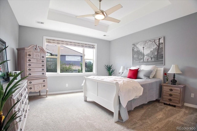 6254 S Riviera Ct, Aurora, CO 80016 - carpeted bedroom featuring a tray ceiling, baseboards, and a ceiling fan
