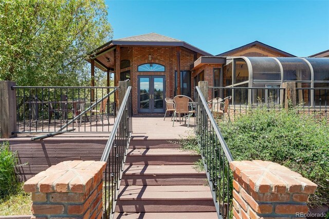 rear view of house featuring french doors