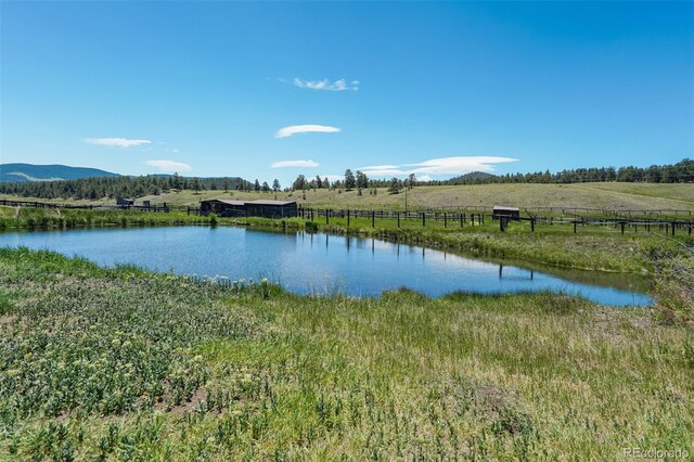 view of water feature with a mountain view and a rural view