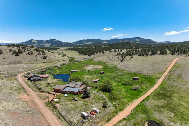 drone / aerial view featuring a rural view and a mountain view