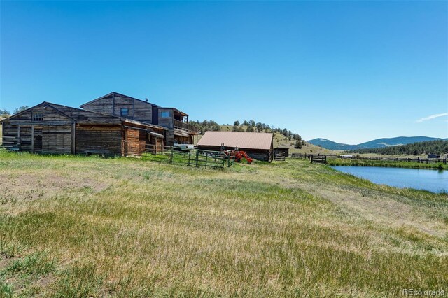 view of yard featuring a water and mountain view