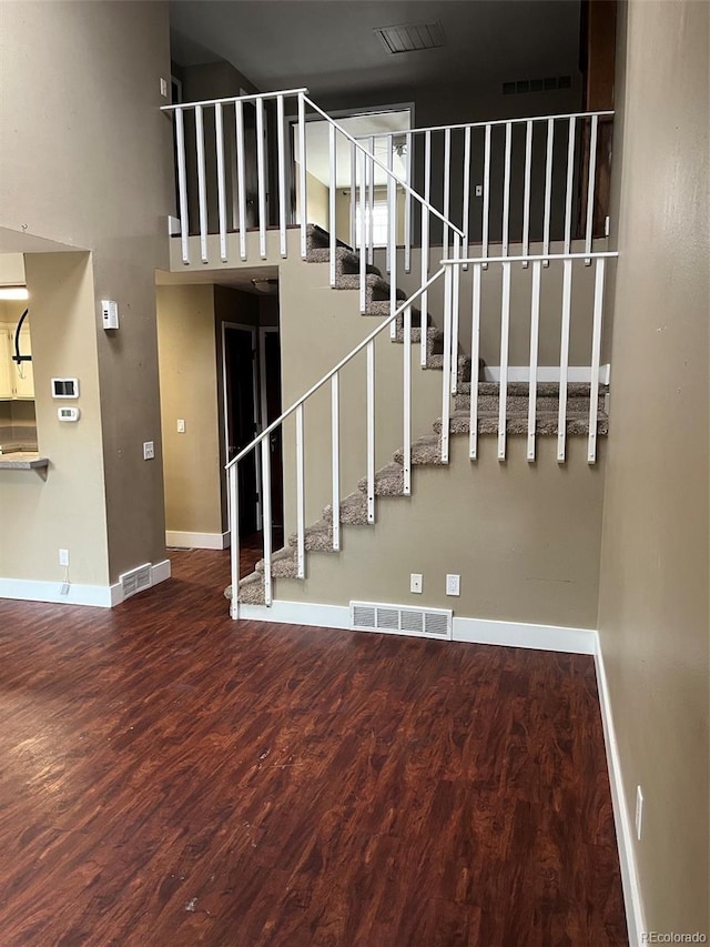 stairway featuring baseboards and wood finished floors