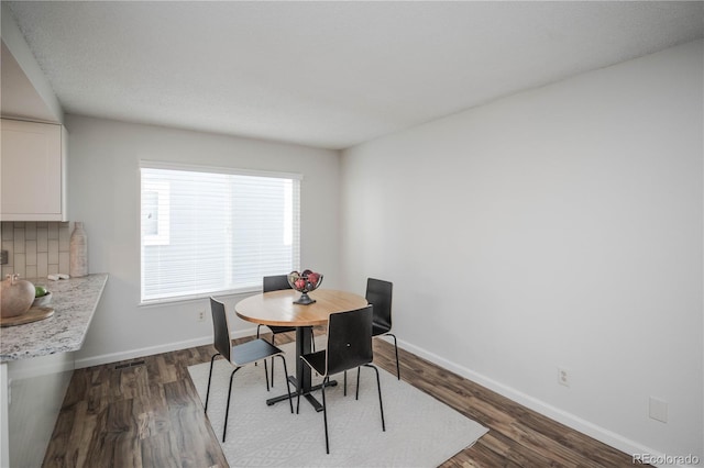 dining room with dark hardwood / wood-style flooring