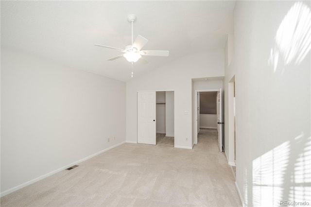 unfurnished bedroom with ceiling fan, light colored carpet, high vaulted ceiling, and a closet