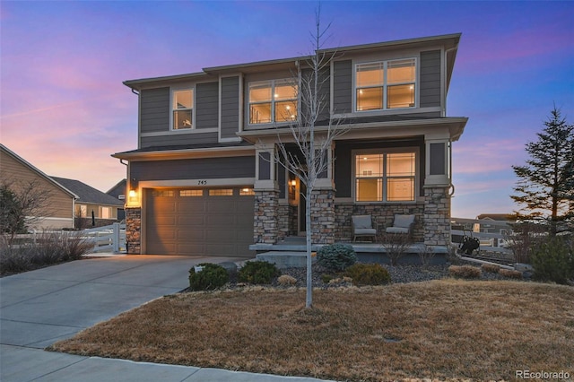 view of front of house with stone siding, driveway, and an attached garage