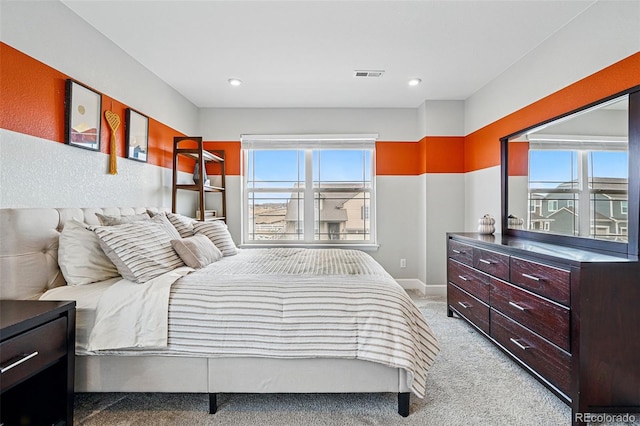 bedroom featuring baseboards, visible vents, and light carpet