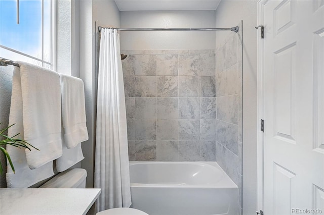 bathroom featuring toilet, vanity, and shower / tub combo with curtain