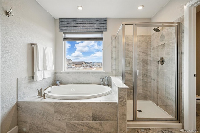 bathroom featuring toilet, a bath, and a shower stall