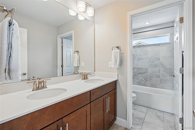 full bath with double vanity, a sink, toilet, and  shower combination
