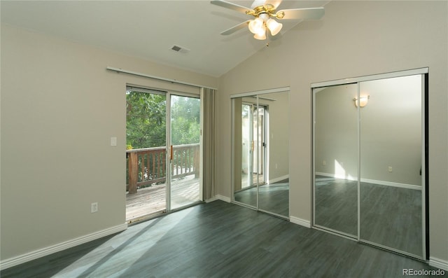 unfurnished bedroom featuring wood finished floors, visible vents, baseboards, access to outside, and two closets