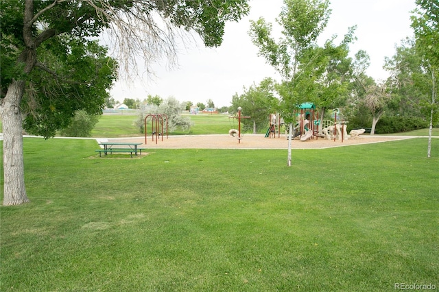 view of community featuring playground community and a lawn