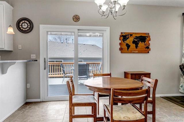 dining space with baseboards and a notable chandelier