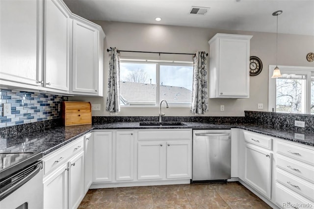 kitchen featuring dishwasher, decorative light fixtures, a sink, and white cabinetry