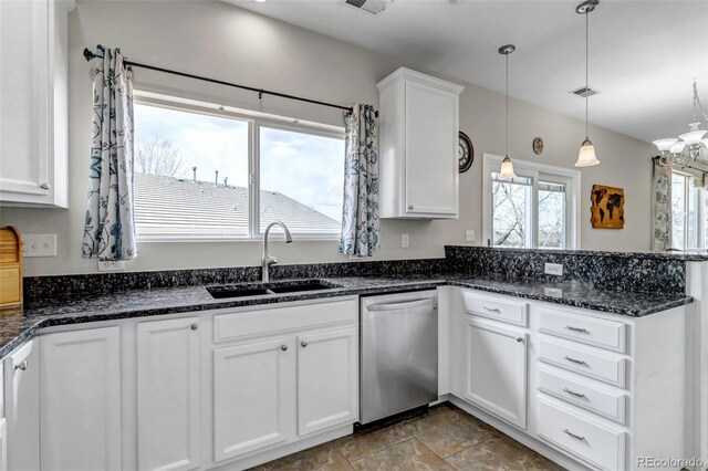 kitchen with a peninsula, stainless steel dishwasher, a sink, white cabinetry, and pendant lighting