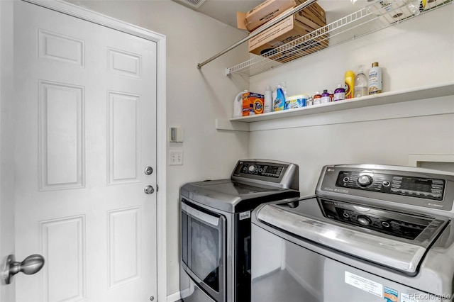 washroom featuring washing machine and clothes dryer and laundry area