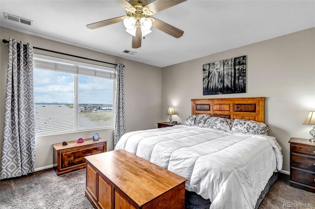 bedroom with baseboards, visible vents, and carpet