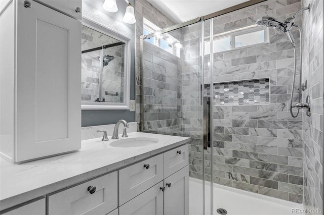 bathroom with vanity, a stall shower, and plenty of natural light