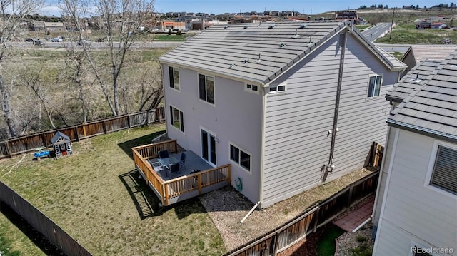 view of home's exterior with a lawn, a fenced backyard, and a wooden deck