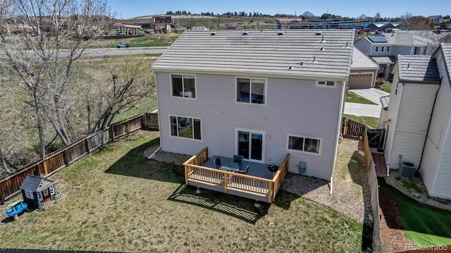 back of property featuring a residential view, a lawn, a fenced backyard, and a deck